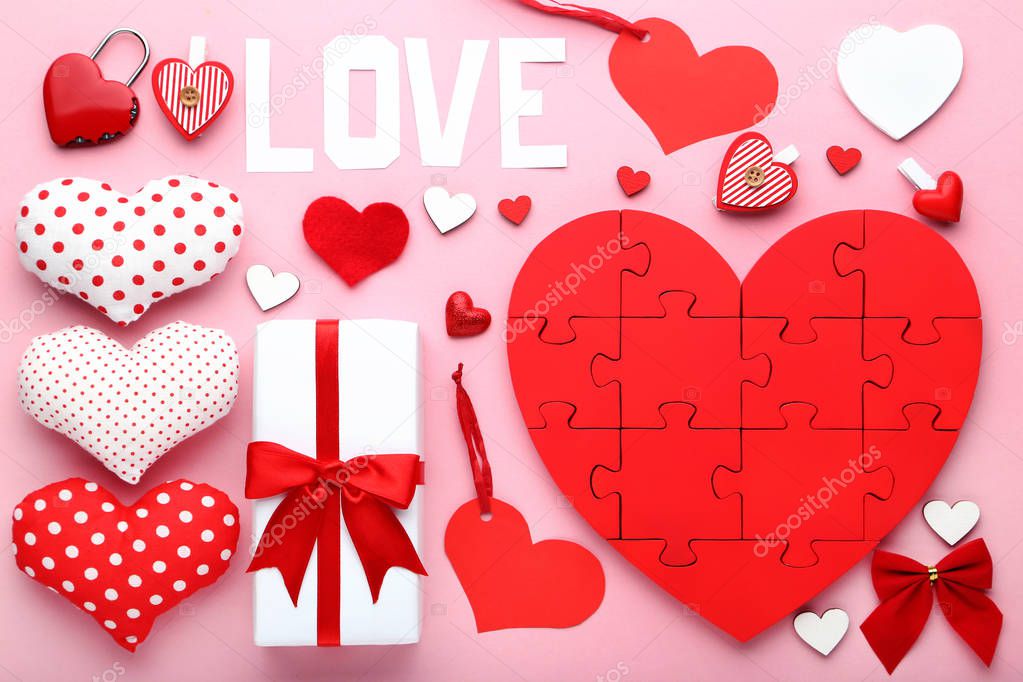 Red and white hearts with gift box on pink background