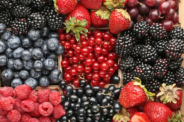 Ripe and sweet berries in wooden box