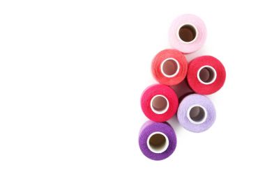 Colourful thread spools isolated on a white clipart