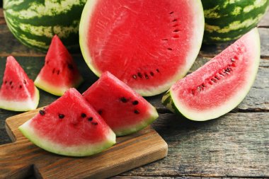 Slices of watermelons on cutting board clipart