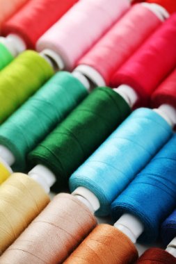 Background of colourful thread spools clipart