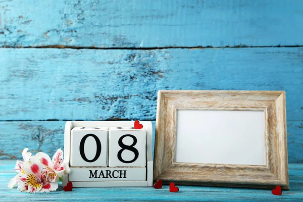 Wooden cube calendar with frame and flowers