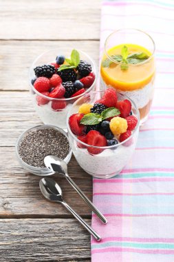 Chia pudingi çilek gri ahşap masa üzerinde gözlük ile