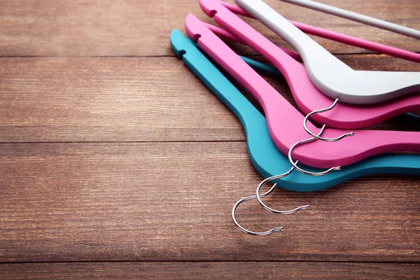 Colorful Hangers Brown Wooden Table — Stock Photo, Image