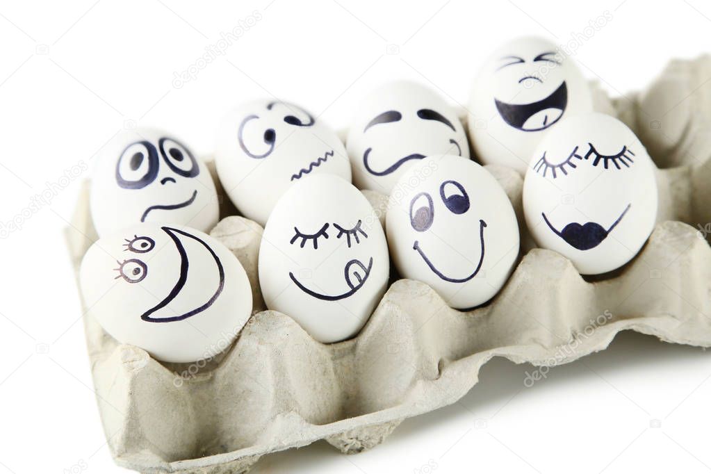 Eggs with funny faces in carton package