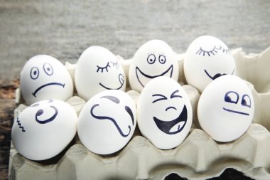 Yumurta karton paket ahşap masa üzerinde komik yüzü olan