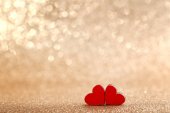 Red wooden hearts on lights background