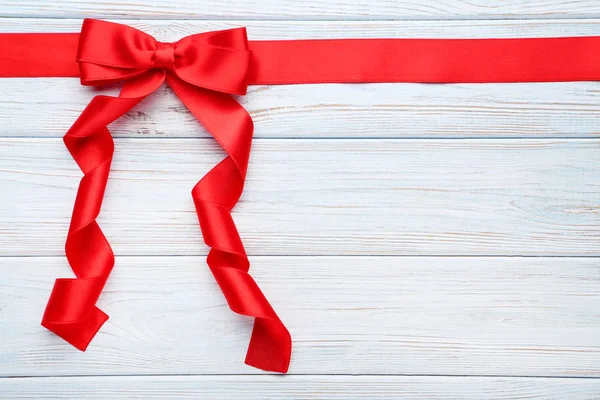 Red Bow Ribbon Wooden Table — Stock Photo, Image