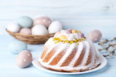 Easter cake with eggs on wooden table clipart