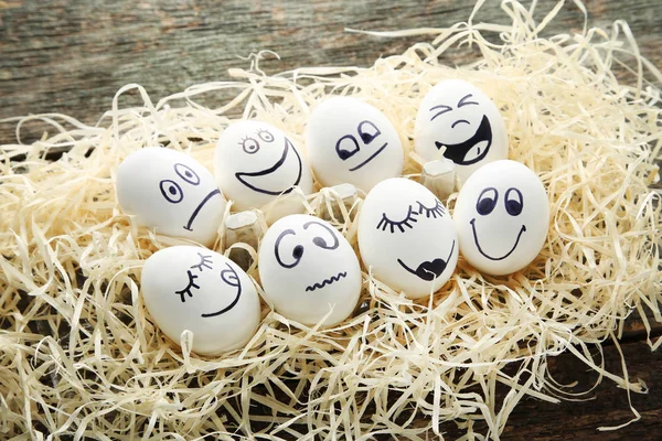 Ovos Com Rostos Engraçados Ninho Mesa Madeira — Fotografia de Stock