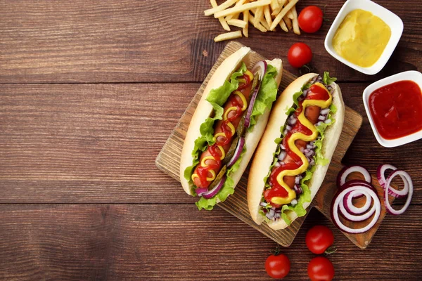 Hot Dogs Vegetables French Fries Wooden Table — Stock Photo, Image