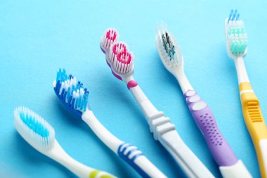 Toothbrushes on blue background clipart