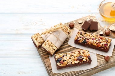 Lezzetli granola barlar ile fındık ve çikolata parçaları ahşap tablo