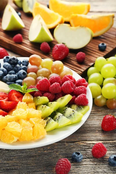 Chopped fresh fruits arranged on cutting board on white wooden surface, top  view. Ingredients for fruit salad. From above, flat lay, overhead Stock  Photo - Alamy