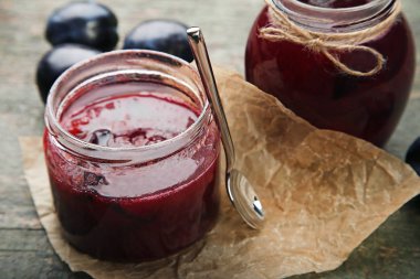 Erik reçeli kavanozlara gri ahşap masa kaşık ile