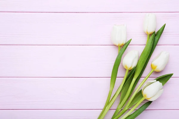 stock image Bouquet of white tulips on pink wooden table