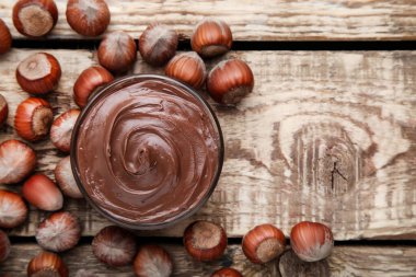 Kahverengi ahşap masada fındık ile erimiş çikolata