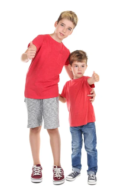 Two young brothers showing thumbs up on white background — Stock Photo, Image