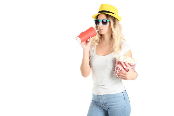 Young woman holding bucket with popcorn and paper cup on white b — Stock Photo, Image