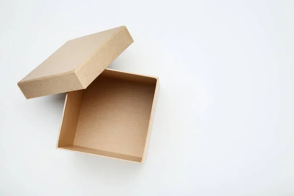 Open brown gift box on white background — Stock Photo, Image