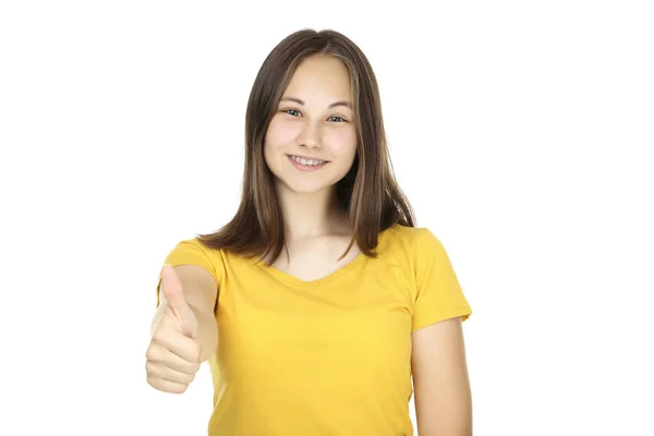 Mladá dívka ukazující palec nahoru na bílém pozadí — Stock fotografie