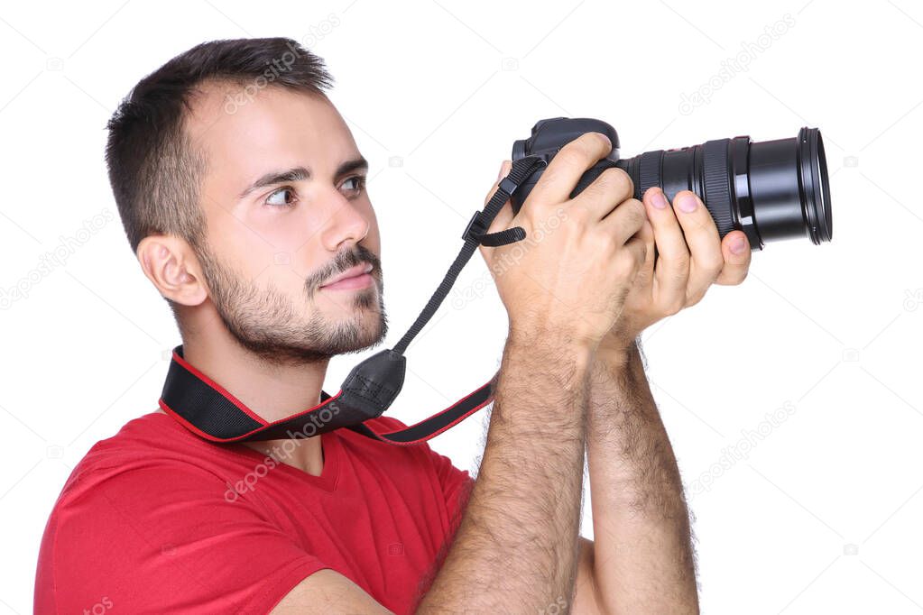 Young photographer with camera on white background