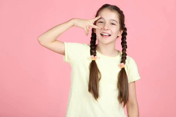 Beautiful young girl on pink background — Stock Photo, Image