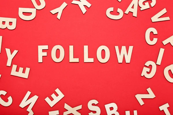 Word Follow by wooden letters on red background — Stock Photo, Image