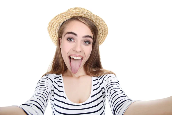 Young beautiful girl in hat making selfie on white background — Stock Photo, Image