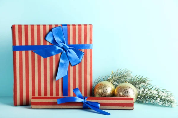 Cajas de regalo con adornos y ramas de abeto sobre fondo azul — Foto de Stock