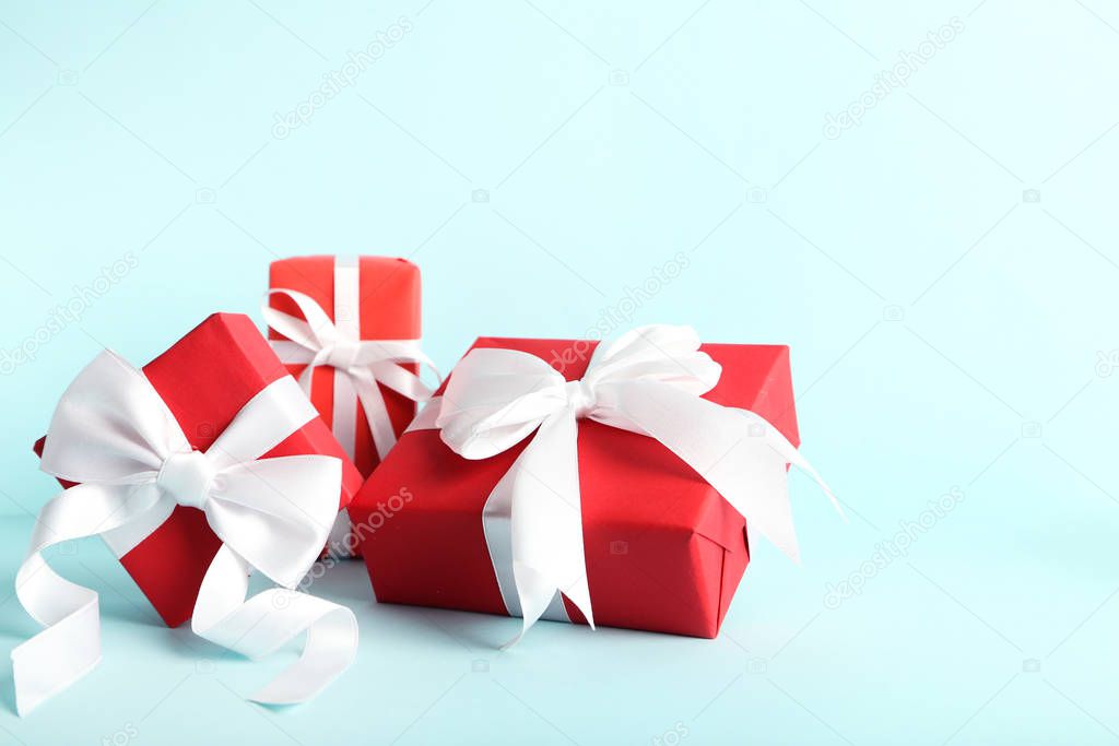 Gift boxes with ribbons on blue background