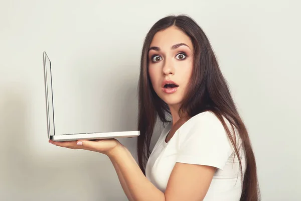 Tânără fată cu laptop computer pe fundal gri — Fotografie, imagine de stoc