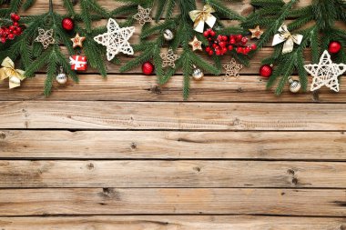 Kahverengi ahşap masada oyuncakları olan Noel ağacı dalları