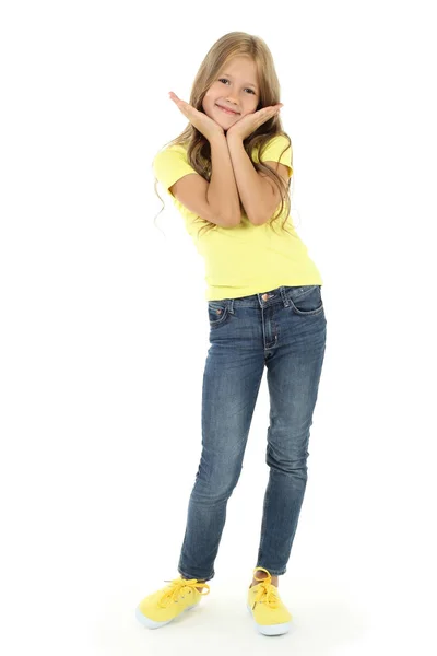 Active cheerful baby kid girl in blue shirt and gold leather pants is cool  posing with her hands in her pockets, smiling Stock Photo