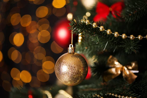 Christmas fir tree with ornaments on blurred lights background — Stock Photo, Image