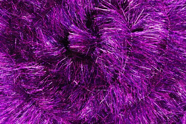Фон фиолетовой рождественской мишуры — стоковое фото