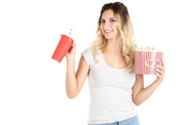 Elinde patlamış mısır ve kağıt bardakla elinde kova tutan genç bir kadın.