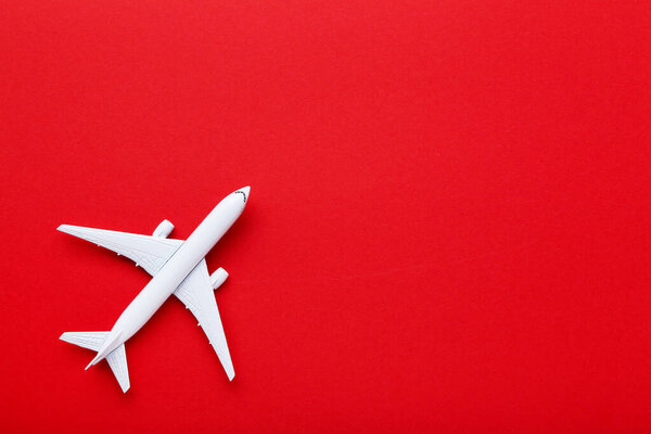 Airplane model on red paper background