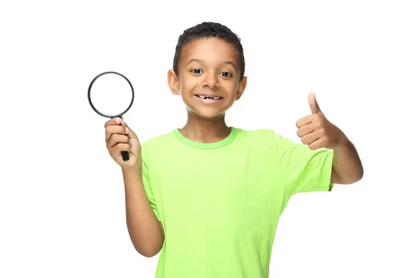 Young African American boy holding loupe and showing thumb up is — 스톡 사진