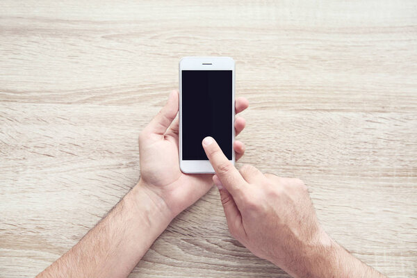 Man holding and using mobile phone