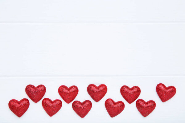 Valentine red hearts on white wooden table