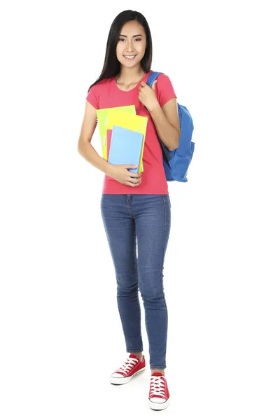 Молодая женщина с книгами и рюкзаком на белом фоне — стоковое фото