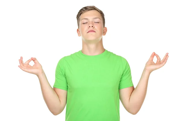 Portrait de jeune homme faisant de la méditation isolé sur fond blanc — Photo