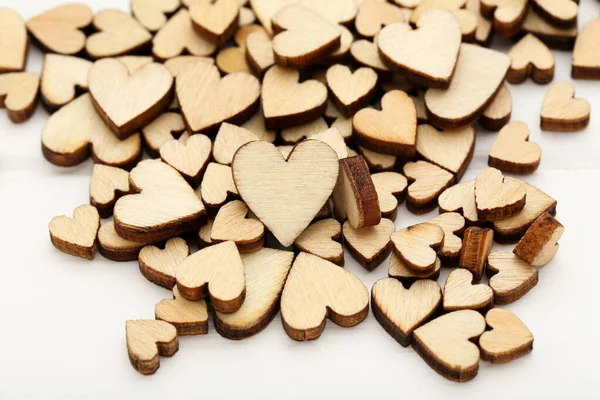 Brązowe serca na białym drewnianym stole — Zdjęcie stockowe