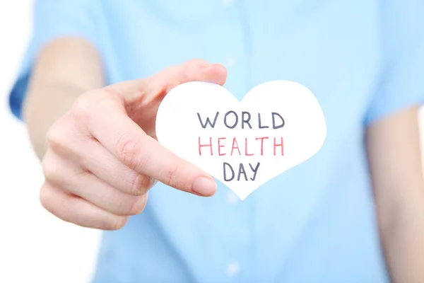 A női kéz egészségügyi világnap szöveggel papír — Stock Fotó