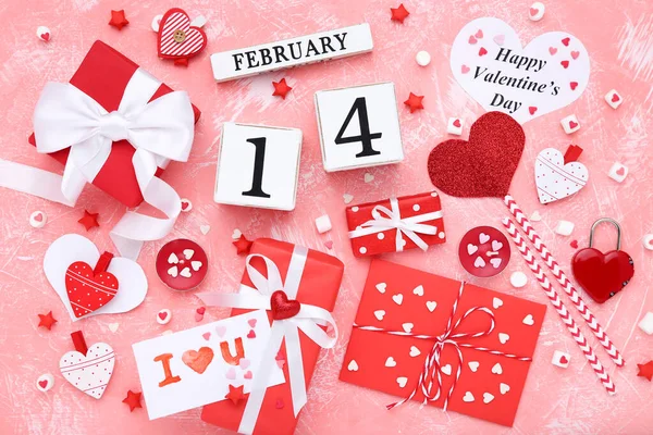 Valentine hearts with cube calendar, gift boxes and candles on c