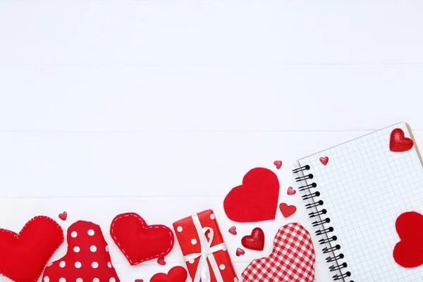 Corazones de San Valentín con caja de regalo y bloc de notas en mesa de madera blanca —  Fotos de Stock