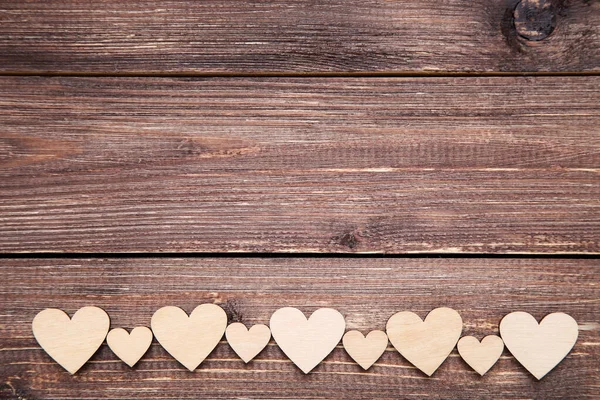 Valentine hearts on brown wooden table — Stock Photo, Image