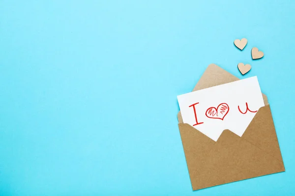 Paper enjoy with hearts and text I Love You on blue backgroun — стоковое фото