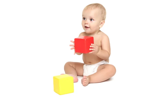 Beautiful little boy in diaper with plastic cubes isolated on wh — Stock Photo, Image